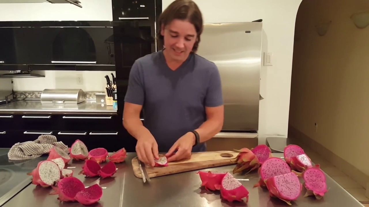 Seven exotic dragon fruit varieties cut in half displaying colorful flesh - white, red, yellow, and purple varieties